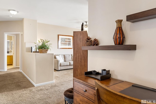 hallway with carpet flooring and baseboards