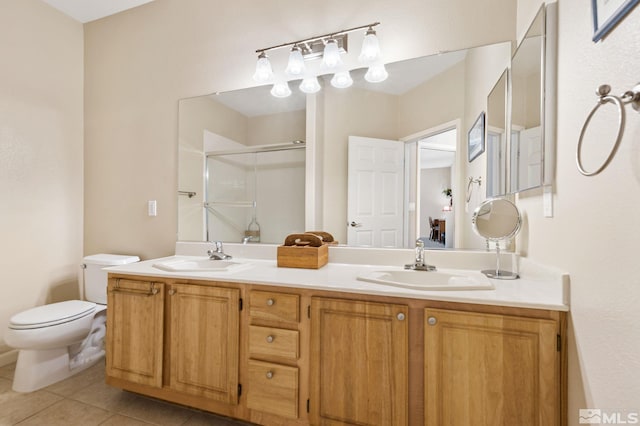 full bathroom with tile patterned flooring, a sink, a shower stall, and toilet