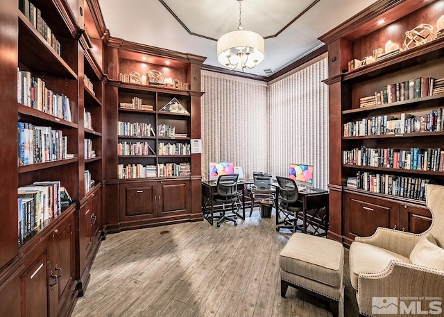 office featuring light wood-type flooring, an inviting chandelier, and ornamental molding