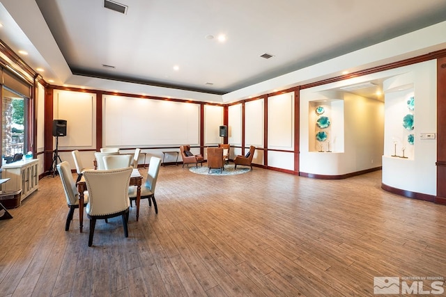 dining room featuring visible vents, baseboards, and wood finished floors