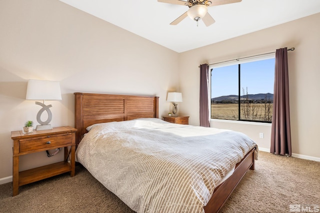 carpeted bedroom with ceiling fan and baseboards