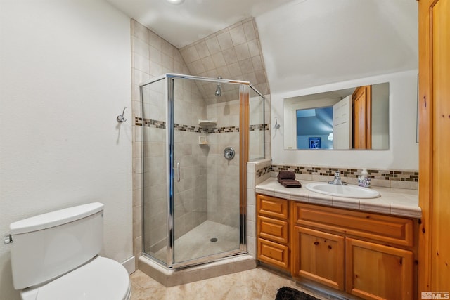 full bathroom with tasteful backsplash, a stall shower, vanity, and toilet