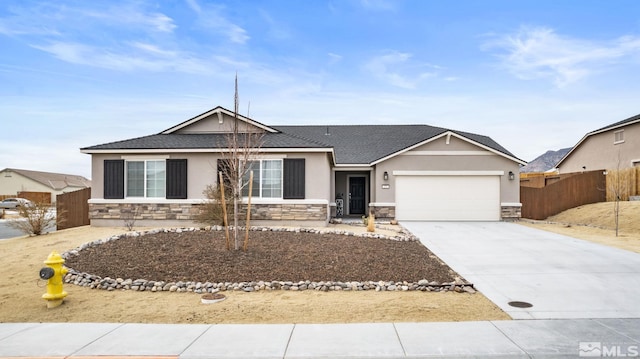 single story home with driveway, stone siding, an attached garage, fence, and stucco siding