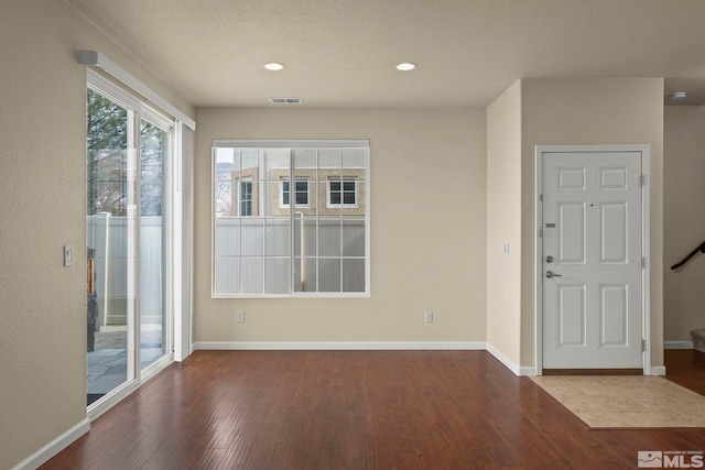 interior space featuring visible vents, baseboards, stairway, wood finished floors, and recessed lighting