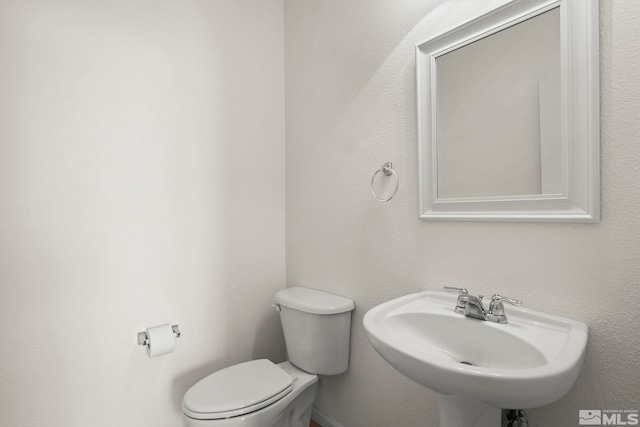 bathroom featuring a sink and toilet