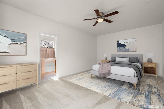 bedroom with baseboards, a ceiling fan, and light colored carpet