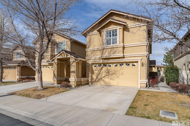 traditional home featuring a garage, driveway, and stucco siding