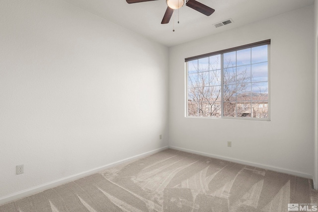 unfurnished room featuring carpet, visible vents, ceiling fan, and baseboards