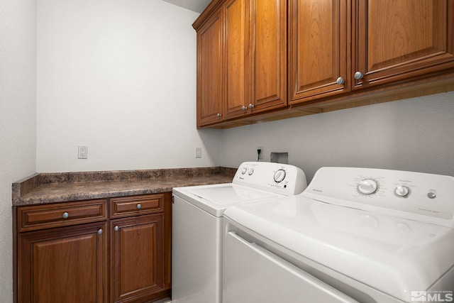 washroom with washer and clothes dryer and cabinet space