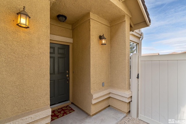 property entrance with stucco siding