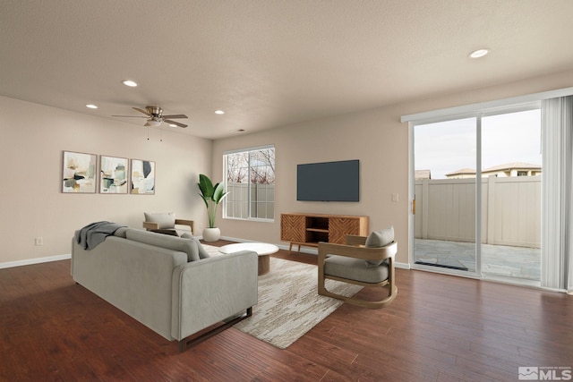 living room featuring baseboards, dark wood finished floors, a ceiling fan, and recessed lighting