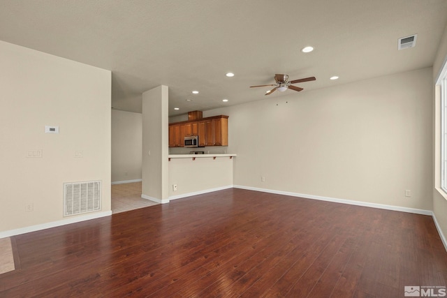 unfurnished living room featuring hardwood / wood-style flooring, visible vents, and recessed lighting