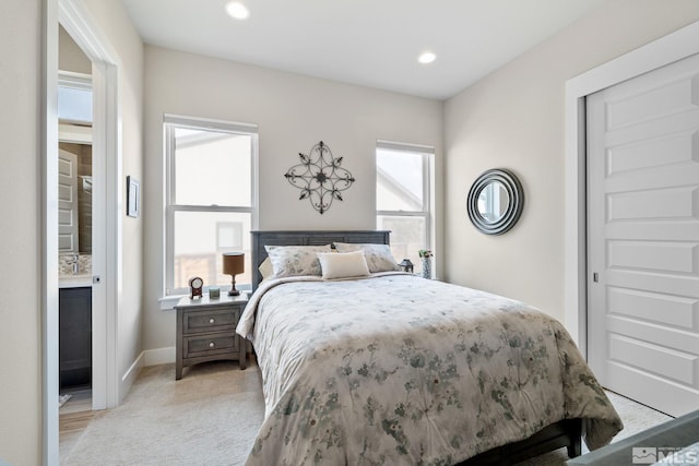 bedroom with baseboards, light carpet, and recessed lighting