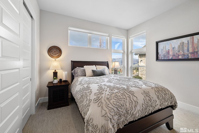 bedroom featuring carpet and baseboards