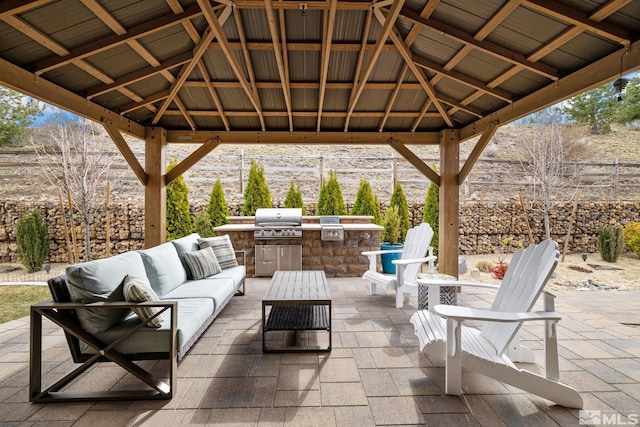 view of patio / terrace featuring an outdoor living space, an outdoor kitchen, grilling area, and a gazebo