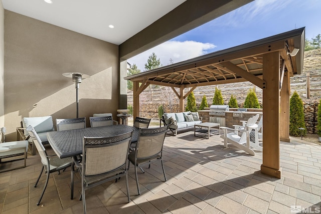 view of patio / terrace with outdoor lounge area, grilling area, a gazebo, outdoor dining space, and exterior kitchen