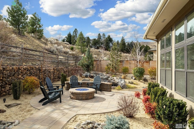 view of patio with a fenced backyard and a fire pit