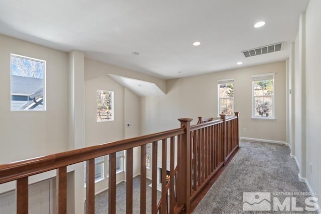 corridor featuring baseboards, visible vents, carpet flooring, an upstairs landing, and recessed lighting