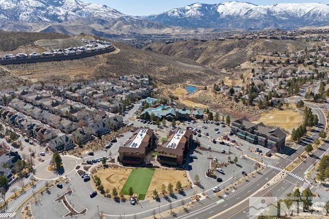 birds eye view of property with a mountain view