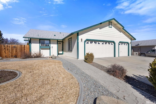 single story home featuring driveway, an attached garage, and fence