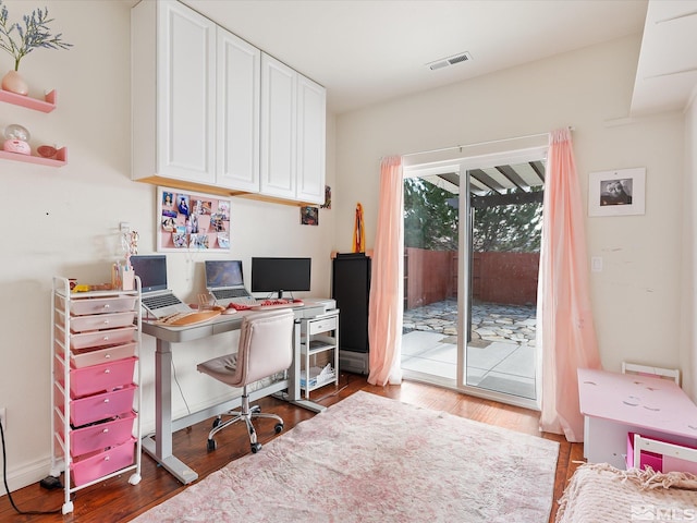 office area with wood finished floors and visible vents