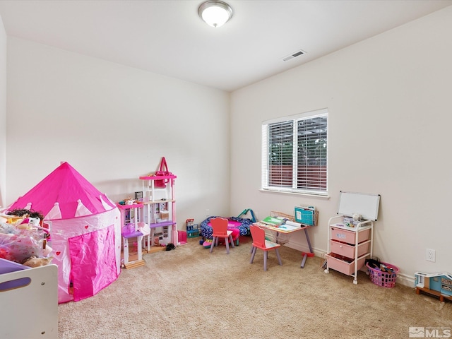 recreation room with carpet flooring, visible vents, and baseboards