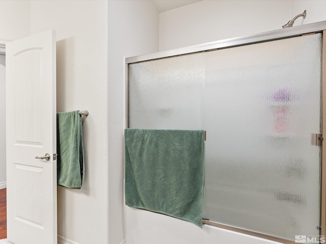 full bathroom featuring a shower with shower door