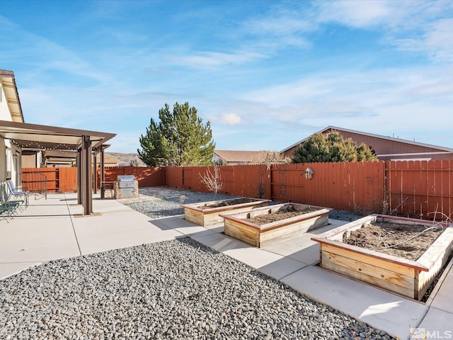 view of yard featuring a garden, a patio, a fenced backyard, and a pergola