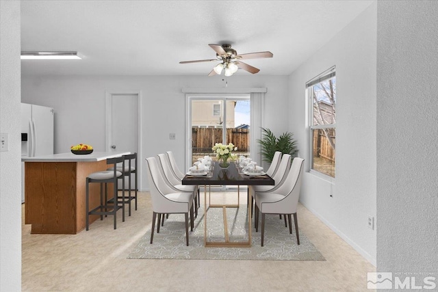 dining room featuring baseboards and a ceiling fan