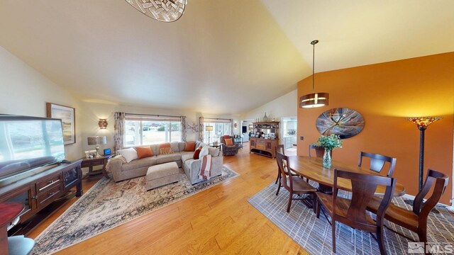 living room with lofted ceiling and wood finished floors