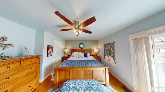 bedroom with visible vents, ceiling fan, light wood-style flooring, and baseboards