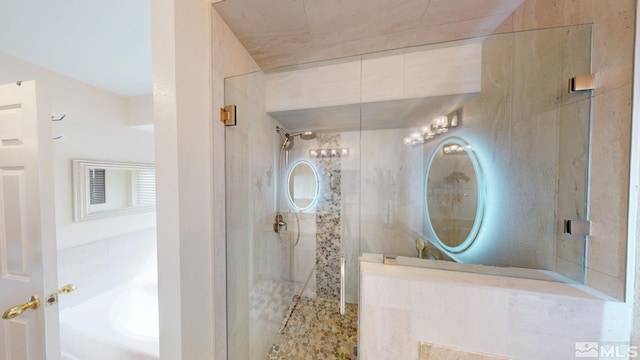 full bathroom featuring a bath and tiled shower