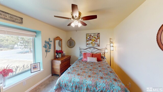 bedroom featuring carpet floors, baseboards, and a ceiling fan