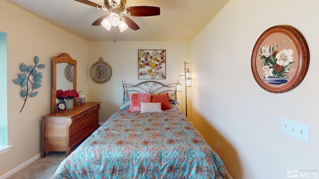 bedroom with a ceiling fan, light colored carpet, and baseboards