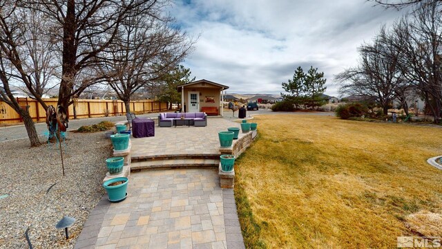 view of yard with an outdoor hangout area, a patio area, and fence