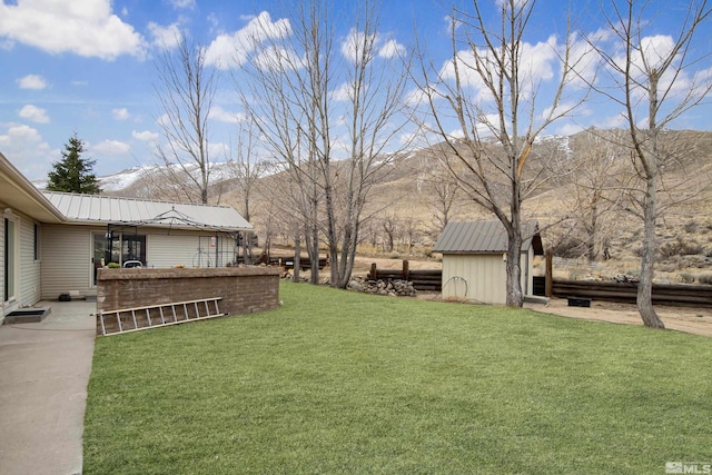 view of yard featuring an outbuilding and a shed