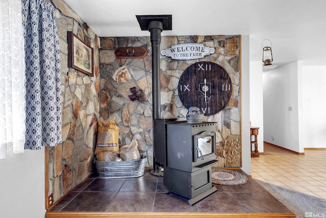 room details with a wood stove and baseboards