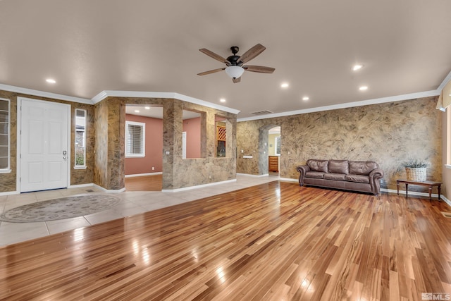 unfurnished living room featuring light wood-style floors, baseboards, crown molding, and recessed lighting