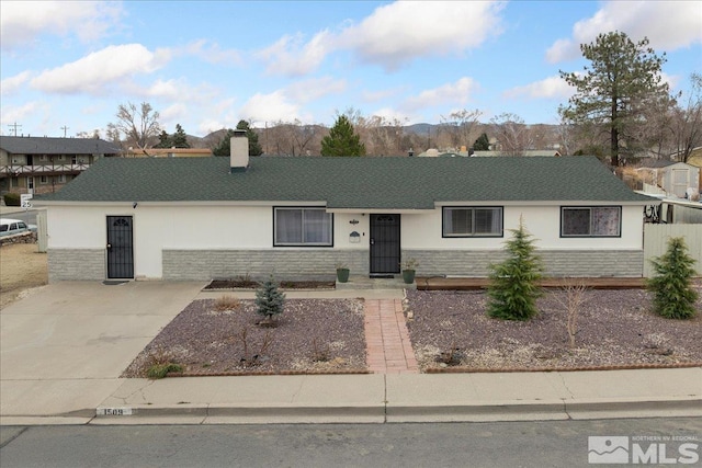 single story home featuring stone siding, a chimney, concrete driveway, and stucco siding