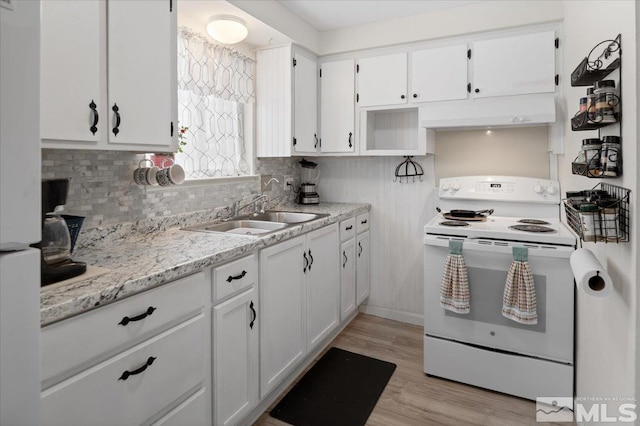 kitchen with white appliances, decorative backsplash, light wood-style flooring, white cabinetry, and a sink