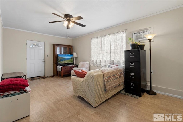 bedroom featuring crown molding, ceiling fan, light wood-type flooring, a wall mounted air conditioner, and baseboards