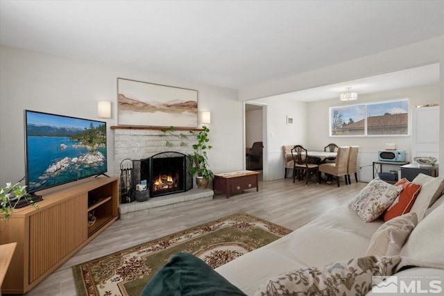 living area with a fireplace and wood finished floors