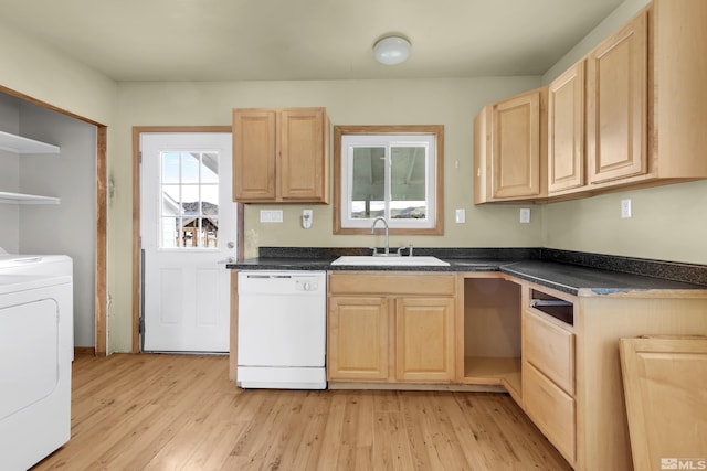 kitchen featuring white dishwasher, light brown cabinets, a sink, washer / clothes dryer, and dark countertops