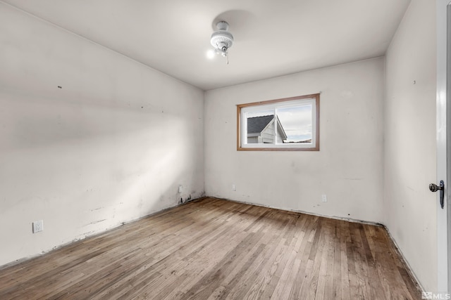 spare room featuring wood finished floors