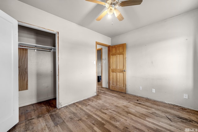 unfurnished bedroom featuring a closet, a ceiling fan, and wood finished floors