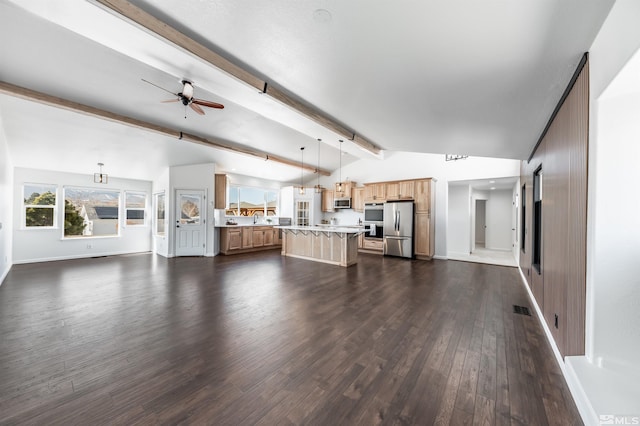 unfurnished living room featuring dark wood finished floors, lofted ceiling with beams, a sink, ceiling fan, and baseboards