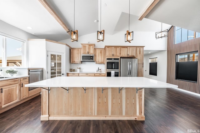 kitchen featuring light brown cabinets, appliances with stainless steel finishes, dark wood finished floors, and beam ceiling