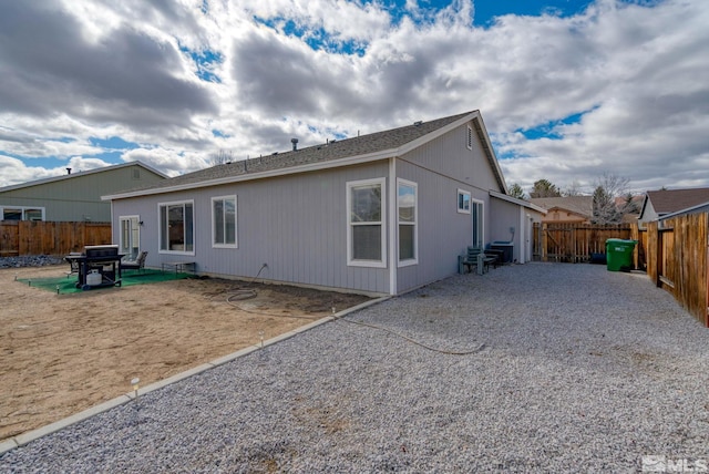 rear view of house with a patio area and a fenced backyard