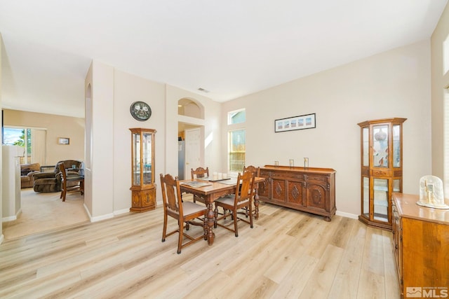 dining space with light wood-type flooring, baseboards, and visible vents