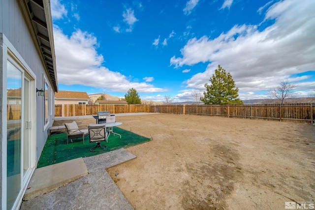 view of yard featuring a patio area and a fenced backyard